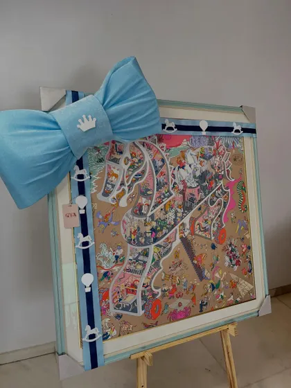 A beautifully framed piece of art, part of a larger gift set for a baby boy.