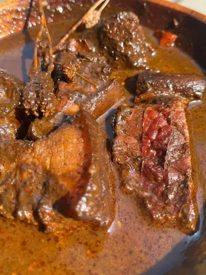 This is our Smoked Pork with Anishi, a rare and traditional black curry from the Ao Naga tribe. The rich, smoky flavor of the pork blends perfectly with the earthy, unique taste of the Anishi, which is made from smoked taro leaves.
