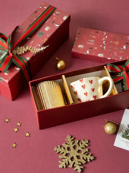 Cozy up with our Merry Moments Christmas Hamper, which includes a heart-themed mug, brownie bites, and a spiced scent candle.