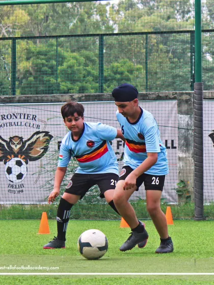 Two players working on their shielding and dribbling skills. Peer-based drills are a great way to simulate match situations.