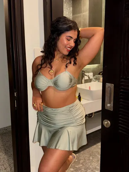 A happy, smiling shot before heading out. Feeling good in your outfit is the first step to having a great time.
