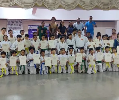 Parents and instructors join the students for a group photograph at the Silicon City dojo, celebrating the achievements of the karateka as a community.