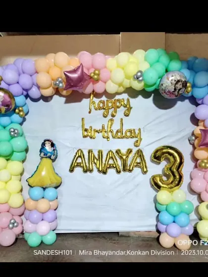 A colorful pastel balloon arch for a 3rd birthday. This home setup includes foil balloons for the name and age, with a Snow White cutout adding a touch of princess magic.