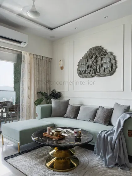A closer look at the custom L-shaped sofa, draped in a sophisticated teal fabric. The pouf is movable, allowing the seating to be reconfigured, demonstrating my focus on flexible and stylish design.