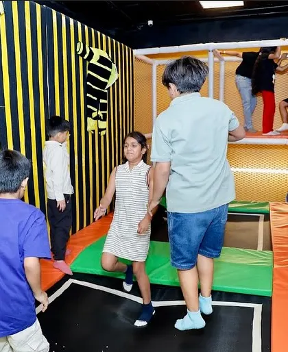 The trampoline area is perfect for kids to jump, play, and have fun with their friends in a safe, netted enclosure.