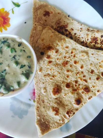 A comforting meal of creamy Methi Mutter Malai, made with fresh fenugreek leaves and green peas, served with a soft paratha.