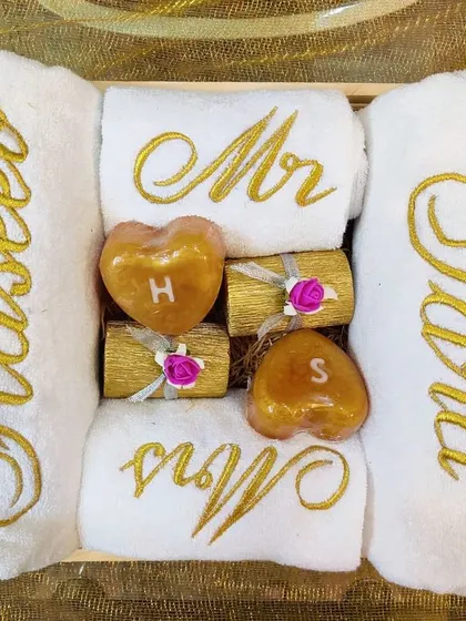This is the perfect couple's hamper! It includes bath towels with the names 'Haseeb' and 'Sana', hand towels with 'Mr' and 'Mrs', and adorable heart-shaped soaps with their initials. Every detail is personalized.
