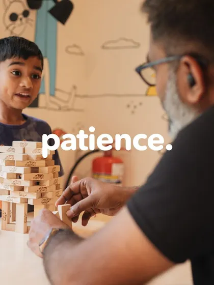 Patience is a virtue, and Jenga is a great teacher! A father and son play Jenga after a public speaking class, a game that requires the same careful thinking and steady hand needed to deliver a great speech.