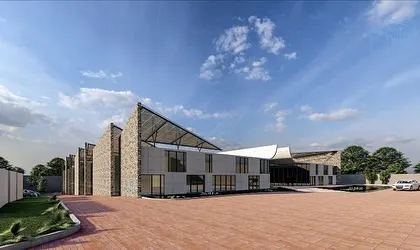 A perspective view of the textile mill, showing the relationship between the administrative blocks and the production areas. The entire campus is designed for logical flow and a cohesive architectural language.