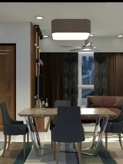 This angle shows the dining area in relation to the living room, featuring a marble-top table and a custom crockery unit with a mirrored back.
