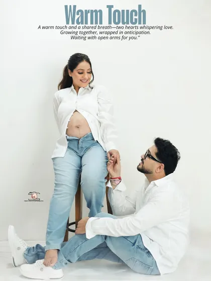 Titled 'Warm Touch', this image shows the dad-to-be looking up lovingly at his partner. The casual styling and genuine emotion make this a heartwarming and relatable portrait.