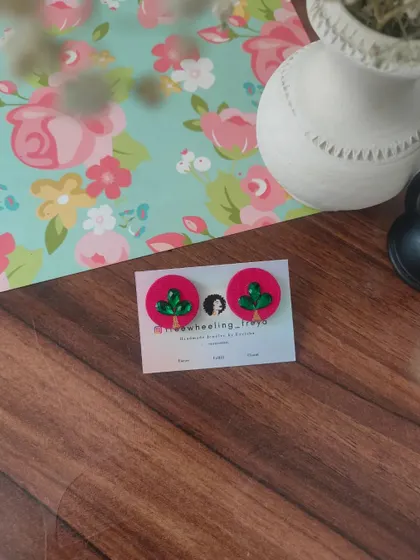 A collection of my simple and elegant fabric studs. Each pair is hand-painted with a small leaf motif and comes in a variety of colors like green, white, yellow, blue, and pink.