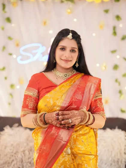 A classic portrait of the mother-to-be at her baby shower. Her traditional attire and the beautifully decorated background come together to create a cherished memory of the event.