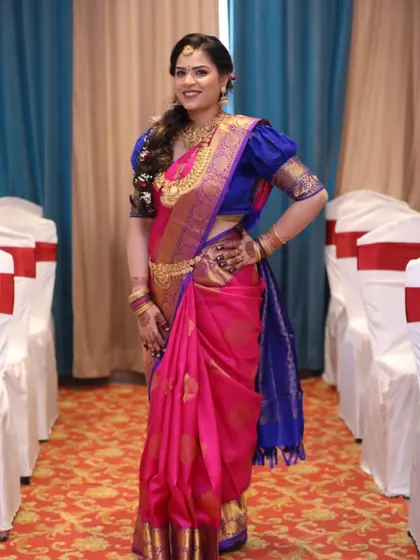 A stunning South Indian bride ready for her ceremony. We created a look that enhances her natural beauty, with a focus on traditional gold jewelry and a beautifully braided hairstyle.