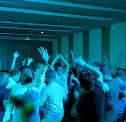 A corporate party for Digital Instruments, with the crowd's hands in the air.