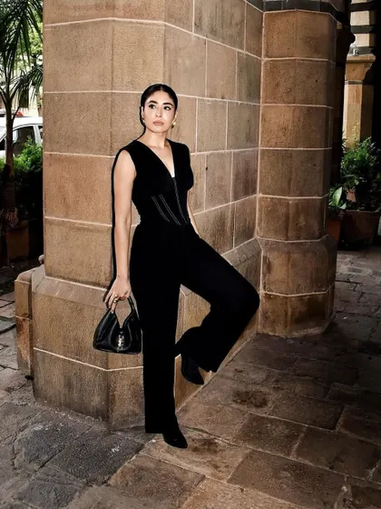 Another shot of this chic all-black look. The architectural background perfectly complements the structured outfit.