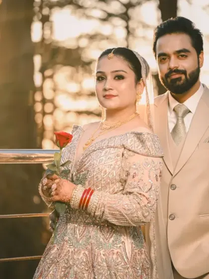 A classic couple portrait taken during the golden hour. The warm, soft light creates a dreamy and romantic mood.