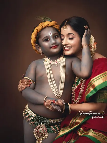 A portrait of maternal love, inspired by the timeless story of Yashoda and Krishna. The rich colors and traditional attire add to the elegance of the photograph.