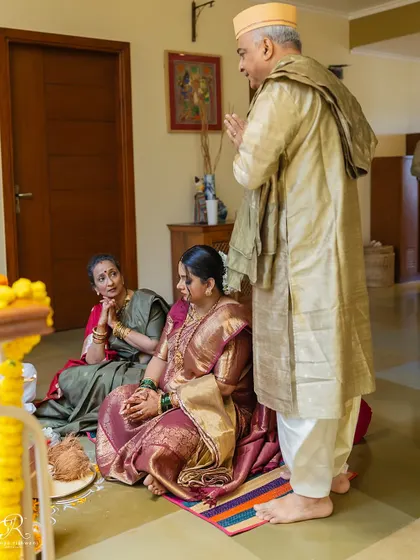 A candid moment during the puja at a home wedding, showing the reverence and emotion of the ceremony.