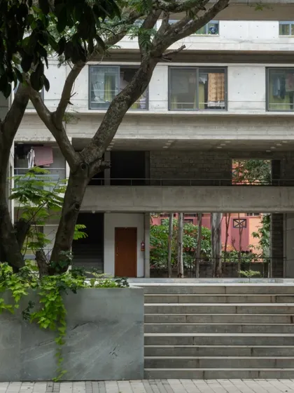 A view through the hostel block, showing layers of space from the courtyard, through the building, to the greenery beyond. This porosity is a key element of our design philosophy.