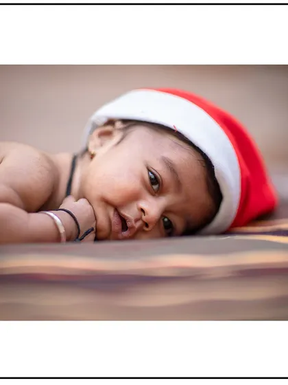Getting into the festive spirit with a themed newborn shoot. This simple Santa hat adds a touch of seasonal fun to this baby's first Christmas portraits.