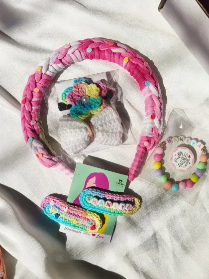 Another beautiful gift hamper, this one for Dhanya. It features a pink braided headband, a personalized bracelet, name clips, and a floral hair tie.