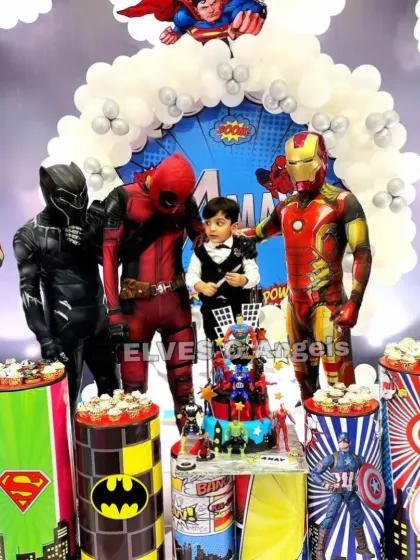 Assembling the ultimate superhero party! This event featured live character mascots including Spider-Man, Deadpool, and Iron Man, posing with the birthday boy for an unforgettable experience. The decor included themed cupcake stands and a full superhero backdrop.