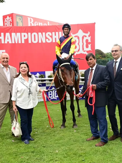 Fynbos, with jockey P. Trevor, poses with the proud owners after a spectacular win.