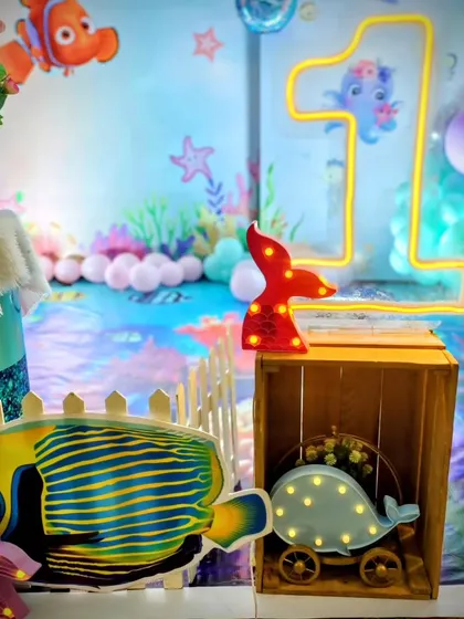 A close-up of the underwater props, including light-up fish and a neon number '1'.