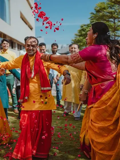 The groom is welcomed with a shower of rose petals, a joyful and colorful start to the ceremony.