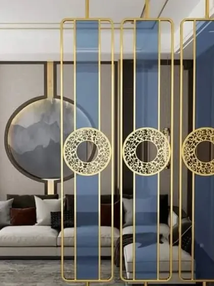 A striking partition design inspired by Asian aesthetics. It features gold-finished frames, blue glass panels, and decorative circular motifs.