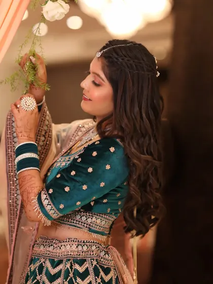 A side profile of the bride, showing how the soft makeup and intricate hairstyle come together. The focus is on her glowing skin and happy expression.