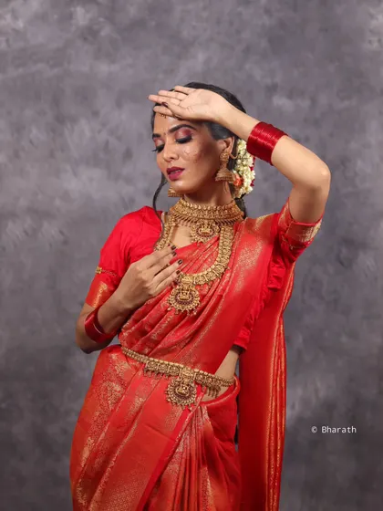 A classic pose for a traditional portrait, with the studio lighting creating a soft yet defined look that highlights the model's features.