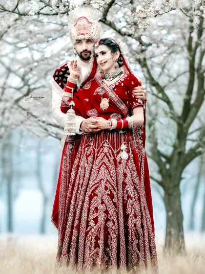 This is what it's all about. A classic wedding portrait where the couple's vibrant red attire stands out beautifully against the serene, almost magical backdrop. I aim to create timeless images like this for you.