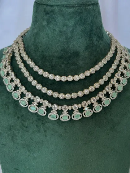 A three-layered American diamond necklace with mint green stones. This rental set is perfect for a daytime event.