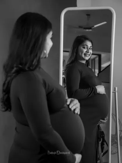A moment of self-love and wonder. Looking in the mirror, this mom-to-be sees the beautiful and strong woman she is, carrying a new life.