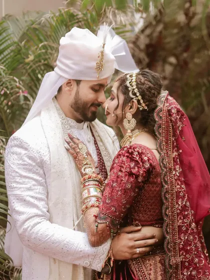 A loving embrace. This portrait showcases the beautiful traditional wedding attire and the deep connection between the couple.