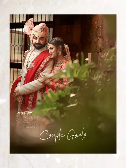 A perfect "Couple Goals" portrait, capturing the bride and groom in a loving embrace, framed beautifully by natural elements.