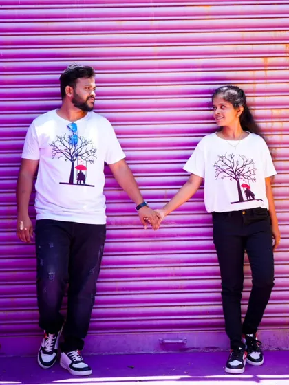 A simple and sweet pre-wedding photo of a couple holding hands against a vibrant purple background. Sometimes, a pop of color is all you need.