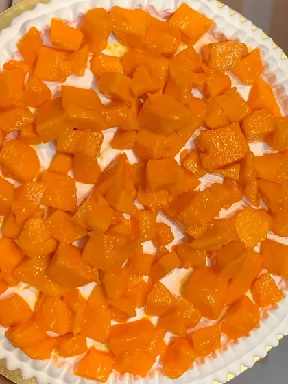 A top-down view of our Mango Cake filling, showcasing the generous amount of fresh, diced mangoes we use.