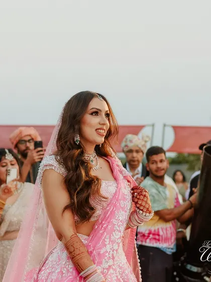 A beautiful candid shot of the bride during her entrance, with guests capturing the moment.