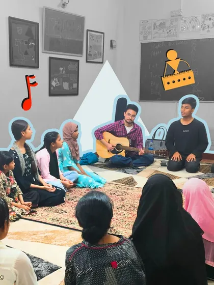 A fellow plays guitar while another facilitates a discussion. This collaborative approach in our after-school programs ensures that every child's voice is heard and valued.