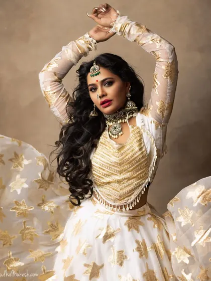 A dynamic shot that highlights the flow of the lehenga and the statement jewellery. The maang tikka and choker are the centerpieces of this look.