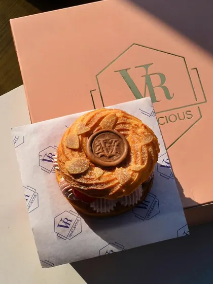 A beautiful shot of our Strawberry Paris-Brest, a delicate choux pastry ring filled with strawberry cream, enjoyed in the golden hour sun.