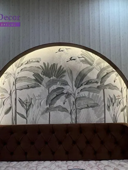 A beautiful example of integrating wallpaper into custom furniture. This monochrome tropical leaf design is installed within a backlit arched headboard, creating a subtle yet stunning focal point in a modern bedroom.