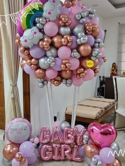 A beautiful "Baby Girl" hot air balloon style bouquet. The mix of pink, rose gold, and silver balloons creates a stunning arrangement to celebrate a new arrival.
