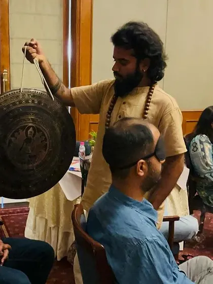Using a Chau gong during a corporate session. The deep, resonant tones of the gong are incredibly powerful for clearing stagnant energy and inducing a state of meditation.