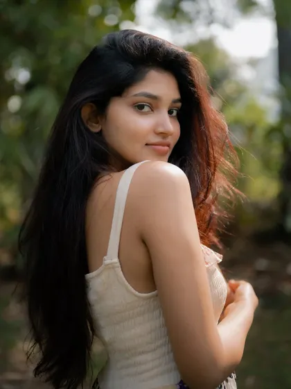 A beautiful portrait of actress Rachana Inder, with the sunlight creating a soft glow in her hair. The natural background adds to the serene and gentle mood.
