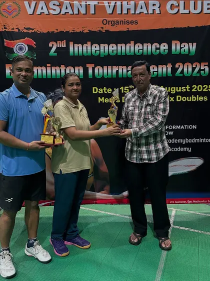 B Group Mixed Doubles winners and runners-up receiving their awards.