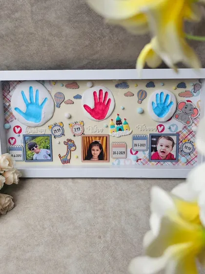 A full view of the sibling impression frame. It's a beautiful piece of decor for a living room or bedroom and a keepsake the family will cherish for a lifetime.